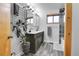 Modern bathroom featuring double sinks, a vanity, a walk-in shower, and stylish fixtures at 30273 Conifer Rd, Evergreen, CO 80439