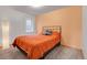 Neutral bedroom featuring a queen bed with gray carpeting, a window, and accent colored walls at 30273 Conifer Rd, Evergreen, CO 80439