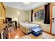 Bedroom with hardwood floors, area rug, and views to the outside at 30273 Conifer Rd, Evergreen, CO 80439