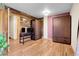 Spacious bedroom with hardwood floors, closet, and wooden accent wall at 30273 Conifer Rd, Evergreen, CO 80439
