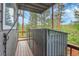 Side view of home's deck with wooded backdrop at 30273 Conifer Rd, Evergreen, CO 80439