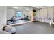 Spacious exercise room with mirrored wall, gym equipment, and rubber flooring at 30273 Conifer Rd, Evergreen, CO 80439
