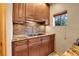 Kitchen featuring wood cabinets, granite countertops, and brick backsplash at 30273 Conifer Rd, Evergreen, CO 80439