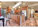 Well-lit kitchen featuring stainless steel appliances, granite countertops, a center island, and wood accents at 30273 Conifer Rd, Evergreen, CO 80439