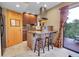 Kitchen featuring wood cabinets, granite countertops, a breakfast bar, and access to the outside deck at 30273 Conifer Rd, Evergreen, CO 80439