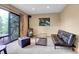 Cozy living room with a wood-burning stove and sliding door to deck and nature at 30273 Conifer Rd, Evergreen, CO 80439