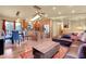 Inviting living room featuring a modern leather sectional, rustic wood accents, and an adjacent dining and kitchen area at 30273 Conifer Rd, Evergreen, CO 80439