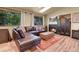 Living room featuring fireplace, wood floors, and large windows at 30273 Conifer Rd, Evergreen, CO 80439