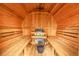 Interior view of the sauna with wooden benches and a traditional heater at 30273 Conifer Rd, Evergreen, CO 80439