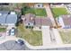 Aerial view of a home with a well-manicured lawn, mature trees, and a driveway with multiple cars at 2399 E 99Th Way, Thornton, CO 80229