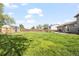 Spacious backyard featuring a well-maintained lawn, a shed, and a wooden fence at 2399 E 99Th Way, Thornton, CO 80229