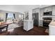 Open-concept living space with hardwood floors, kitchen with island, and modern appliances at 2399 E 99Th Way, Thornton, CO 80229