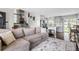 Open-concept living room with gray-toned walls, hardwood floors and modern staircase at 2399 E 99Th Way, Thornton, CO 80229