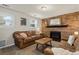 Relaxing living room with a brick fireplace, comfortable couches, and lots of space at 2399 E 99Th Way, Thornton, CO 80229