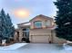 Two-story house with tan exterior, red tile roof, and attached two-car garage at 9688 Colinade Dr, Lone Tree, CO 80124