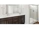 Bathroom featuring a double sink vanity and a glass-enclosed shower at 6531 N Malaya St, Aurora, CO 80019