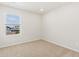 A bright bedroom with tan carpet, a window, and white walls at 6531 N Malaya St, Aurora, CO 80019