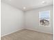 The bedroom features neutral carpet, white walls and a window at 6531 N Malaya St, Aurora, CO 80019
