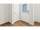 Bright entryway featuring wood-look flooring, white walls, and doors with glass panel at 6531 N Malaya St, Aurora, CO 80019