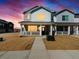 Charming two-story home featuring stone accents, white siding, and a welcoming front porch at 6531 N Malaya St, Aurora, CO 80019