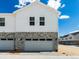 Attached two-car garage featuring stone accents, enhancing the curb appeal of this charming home at 6531 N Malaya St, Aurora, CO 80019