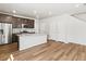 Modern kitchen with dark cabinets, granite countertops, and stainless steel appliances at 6531 N Malaya St, Aurora, CO 80019