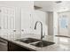 Close up of the island with granite countertops, stainless steel sink, and a modern faucet at 6531 N Malaya St, Aurora, CO 80019