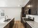 Bright kitchen features stainless appliances, wood-look floors, granite counters and ample cabinet space at 6531 N Malaya St, Aurora, CO 80019