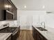 Kitchen features granite counters, stainless appliances, dark cabinets and an island at 6531 N Malaya St, Aurora, CO 80019