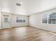 Inviting living room featuring wood-look floors and large windows at 6531 N Malaya St, Aurora, CO 80019