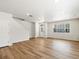 Bright living room with wood-look floors, staircase, and a window with natural light at 6531 N Malaya St, Aurora, CO 80019