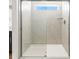 Modern shower featuring a sliding glass door and tile surround at 6531 N Malaya St, Aurora, CO 80019