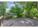 Backyard wooden deck with wood railing overlooking a lush fenced backyard at 8552 Gray Ct, Arvada, CO 80003