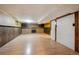 Spacious finished basement with a fireplace, wood paneled accent walls, and laminate flooring at 8552 Gray Ct, Arvada, CO 80003