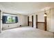 Bright bedroom with neutral carpet, large windows, and a balcony-like space with wood railings at 8552 Gray Ct, Arvada, CO 80003