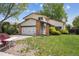Charming two-story home with a well-maintained lawn, attached garage, and inviting curb appeal on a sunny day at 8552 Gray Ct, Arvada, CO 80003