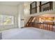 Open-concept living area with hardwood floors, large windows, staircase with wood railing, and kitchen view at 8552 Gray Ct, Arvada, CO 80003