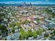 Aerial view of Denver neighborhood with a historic house and city skyline backdrop at 1401 N Franklin St # 1, Denver, CO 80218