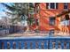 Backyard featuring a well-maintained brick exterior and patio space, partially enclosed by a wooden fence at 1401 N Franklin St # 1, Denver, CO 80218