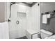 Stylish bathroom with tiled shower featuring a glass door and gray walls at 1401 N Franklin St # 1, Denver, CO 80218