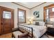 Bedroom featuring a vintage metal bed frame, and wood-trimmed windows at 1401 N Franklin St # 1, Denver, CO 80218