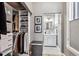 Organized closet with shelving and hanging space, leading to a view of the bathroom at 1401 N Franklin St # 1, Denver, CO 80218