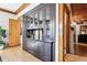 Close-up shot of a dark wood dining room cabinet featuring decorative glassware and ample storage space at 1401 N Franklin St # 1, Denver, CO 80218