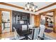 Elegant dining room with vintage-inspired lighting, built-in cabinet, and hardwood floors at 1401 N Franklin St # 1, Denver, CO 80218