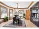 Elegant dining room with hardwood floors, wood trim, a modern chandelier, and large windows at 1401 N Franklin St # 1, Denver, CO 80218