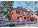 Brick home with blue fence, mature trees and architectural details at 1401 N Franklin St # 1, Denver, CO 80218