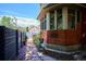 Exterior view of home with bay window, brick accents, and a stone pathway leading to the backyard at 1401 N Franklin St # 1, Denver, CO 80218