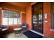 Cozy front porch with brick walls, seating, and a secure front door at 1401 N Franklin St # 1, Denver, CO 80218