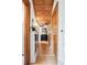 Long hallway with hardwood floors, wood trim, a coffered ceiling, and period lighting at 1401 N Franklin St # 1, Denver, CO 80218