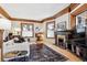 Bright living room featuring hardwood floors, wood trim, a decorative fireplace, and ample natural light at 1401 N Franklin St # 1, Denver, CO 80218